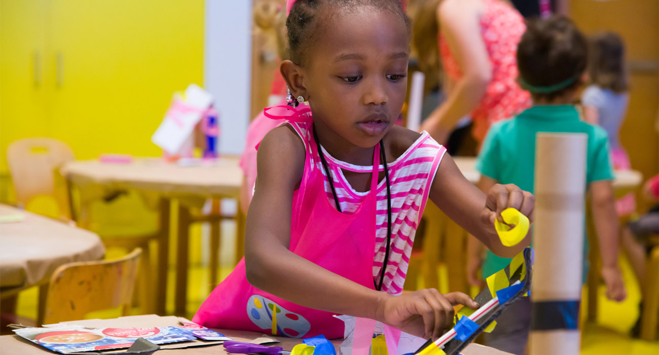 A girl creating a sculpture.