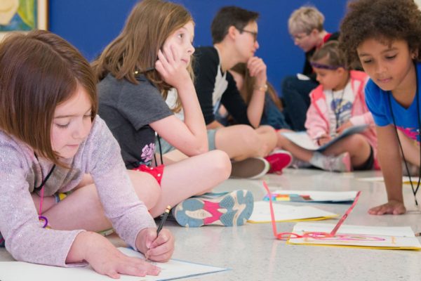 A group of kids drawing.