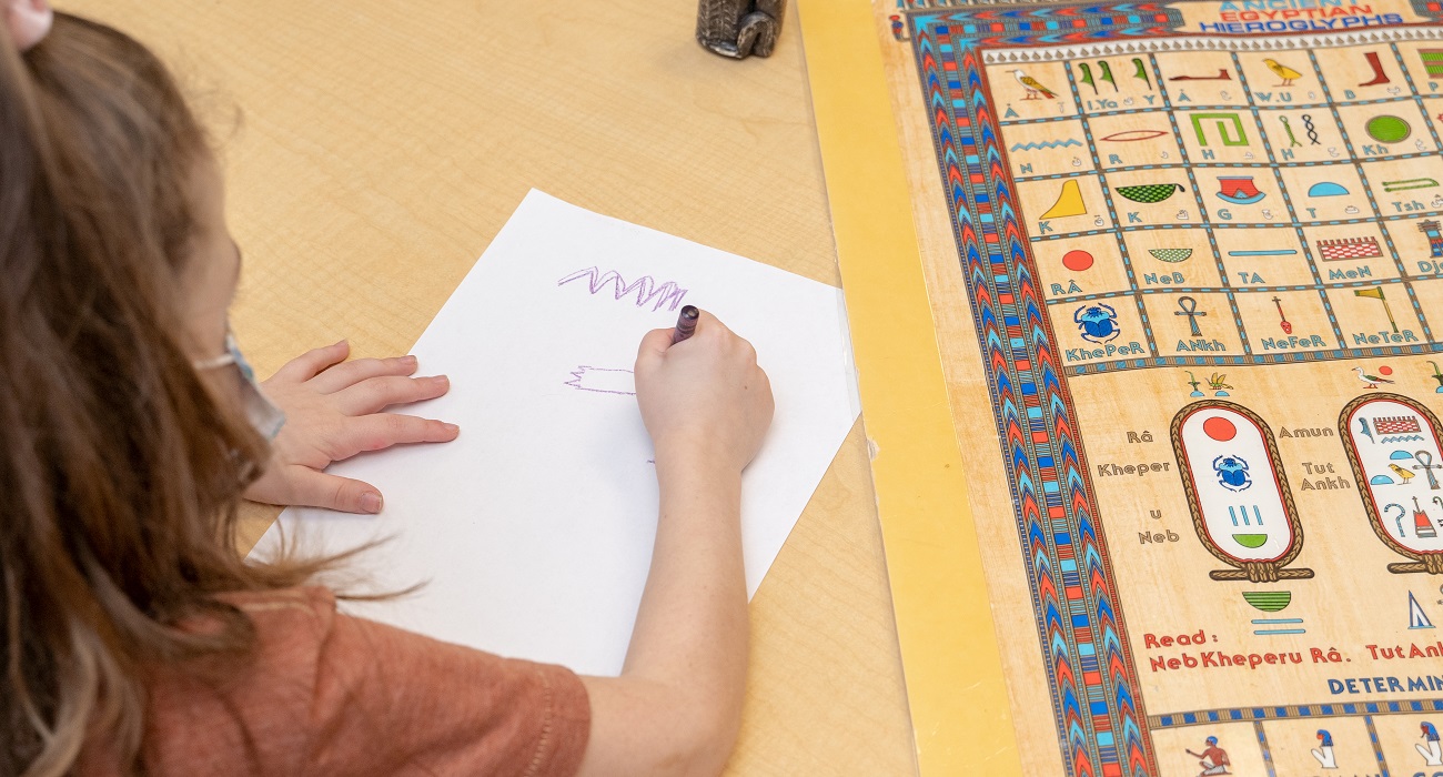 girl writing hieroglyphs