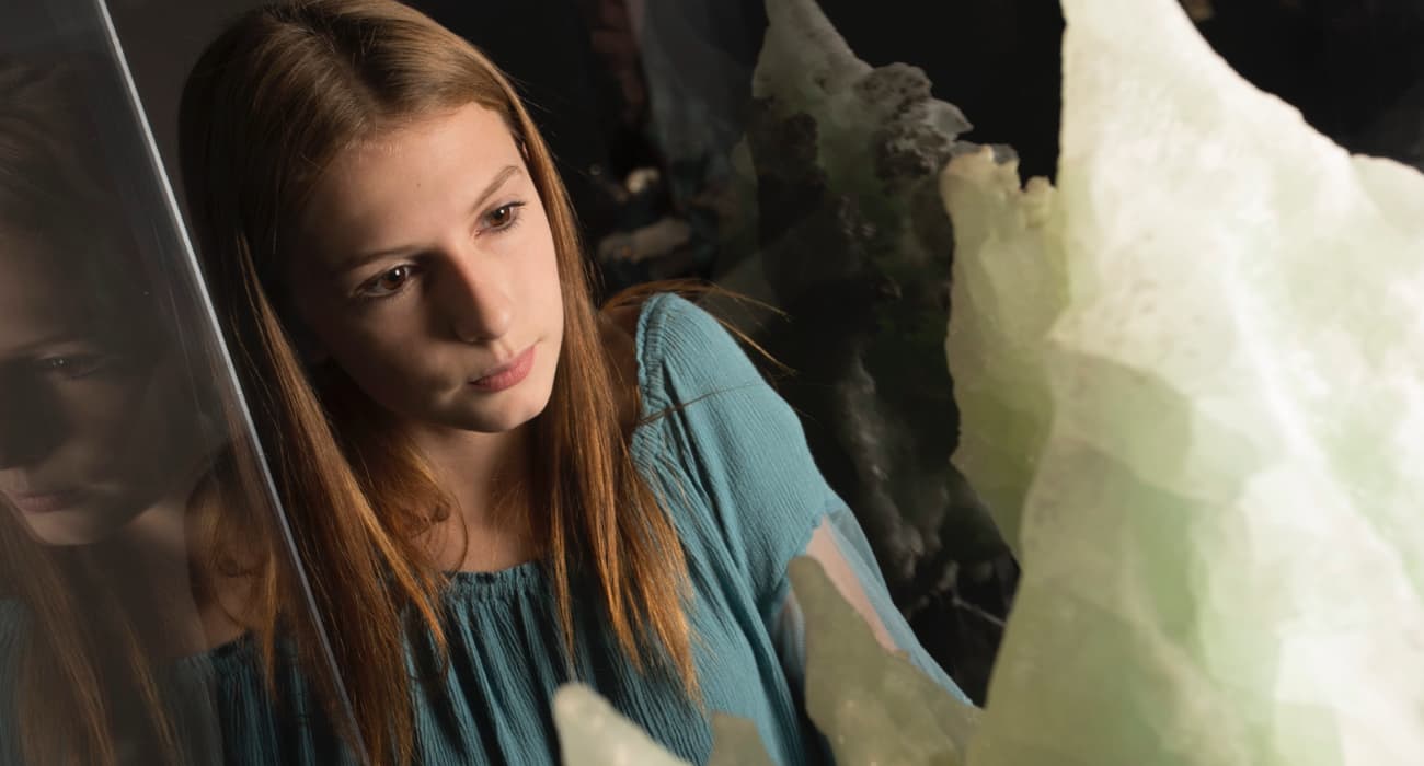 girl looking at mineral