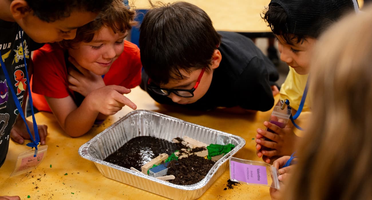 kids looking in dirt pan