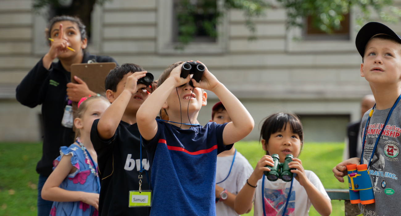 child looking through binoculars