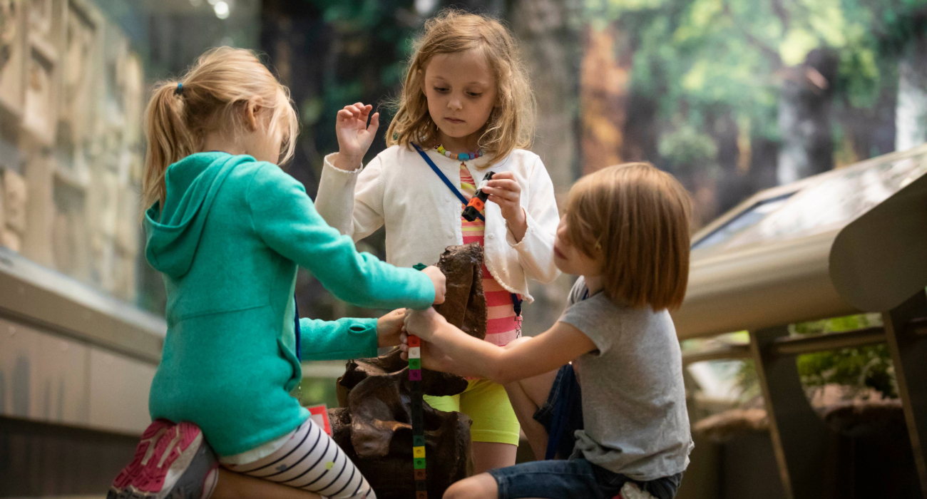 children with dinosaur bones