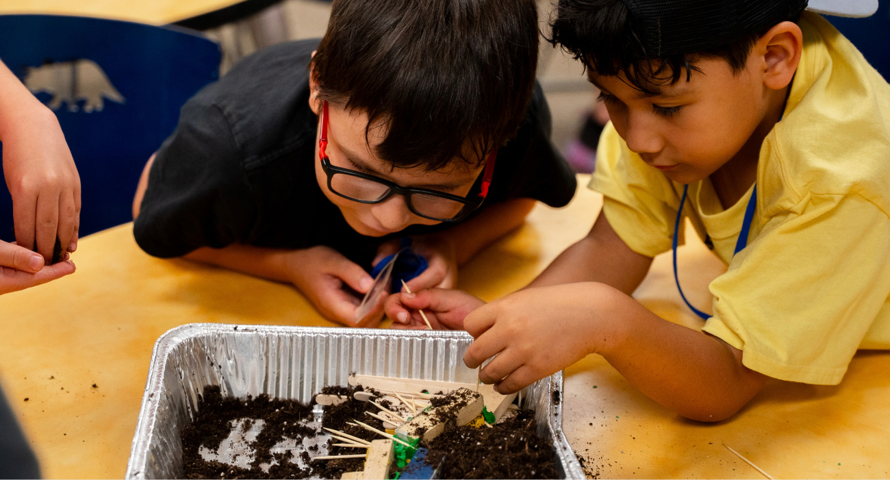 children over a tin of dirt