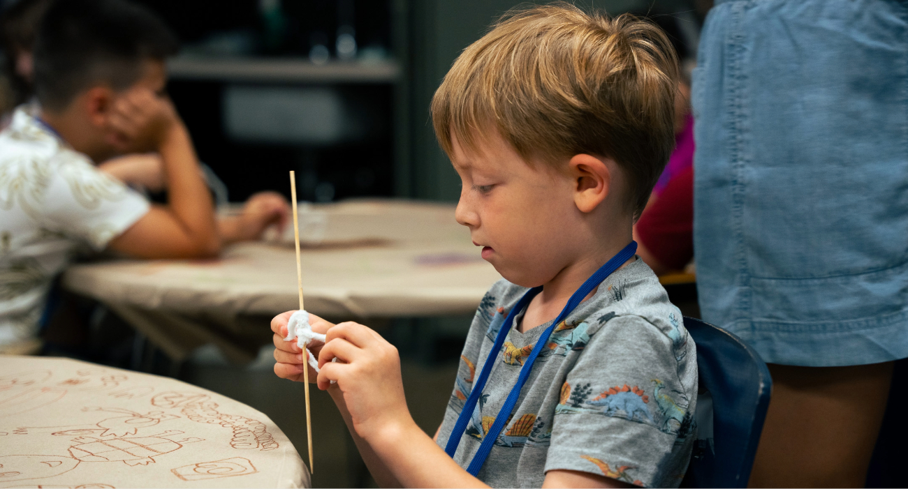 child working on art piece